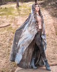 Flowing hooded cloak with tribal patterned trim, unbranded gray tie-dye cotton, draped outdoor silhouette