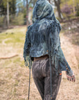 Boho fringe hooded jacket in blue denim with drawstring hood and zipper front — outdoors portrait