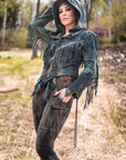 Fringed hooded jacket in charcoal gray suede-like fabric with tasseled sleeves—outdoor look