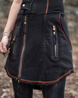 Black denim jacket with red contrast stitching and zip pockets, worn outdoors on a model