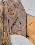 Unbranded taupe canvas hooded jacket with front zipper and drawstring waist on concrete background