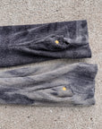 Dark navy sweatshirt cuff with visible knit texture, stitched seam, and snap button detail