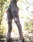 Rugged lace-up leather boots in dark brown with eyelet lacing and thick sole in forest light