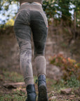 Outdoor black and gray leggings with washed abstract panels on the thighs and calves in park light