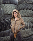 Tan hooded zip jacket, unbranded, with rugged stone texture background, suede-like finish and zip front