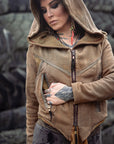 Tan suede zip-up hoodie in taupe with front zipper and drawstring hood, textured fabric visible outdoors