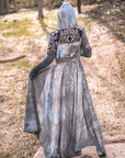 Boho hooded dress in grey tie-dye with navy and cream embroidered yoke panel, shown outdoors on stone path