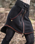 Soft-textured fleece jacket in black with front zipper, orange piping, and visible pocket seams
