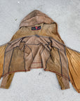Unbranded suede hooded jacket in tan with black trim and drawstring hood, laid open on concrete