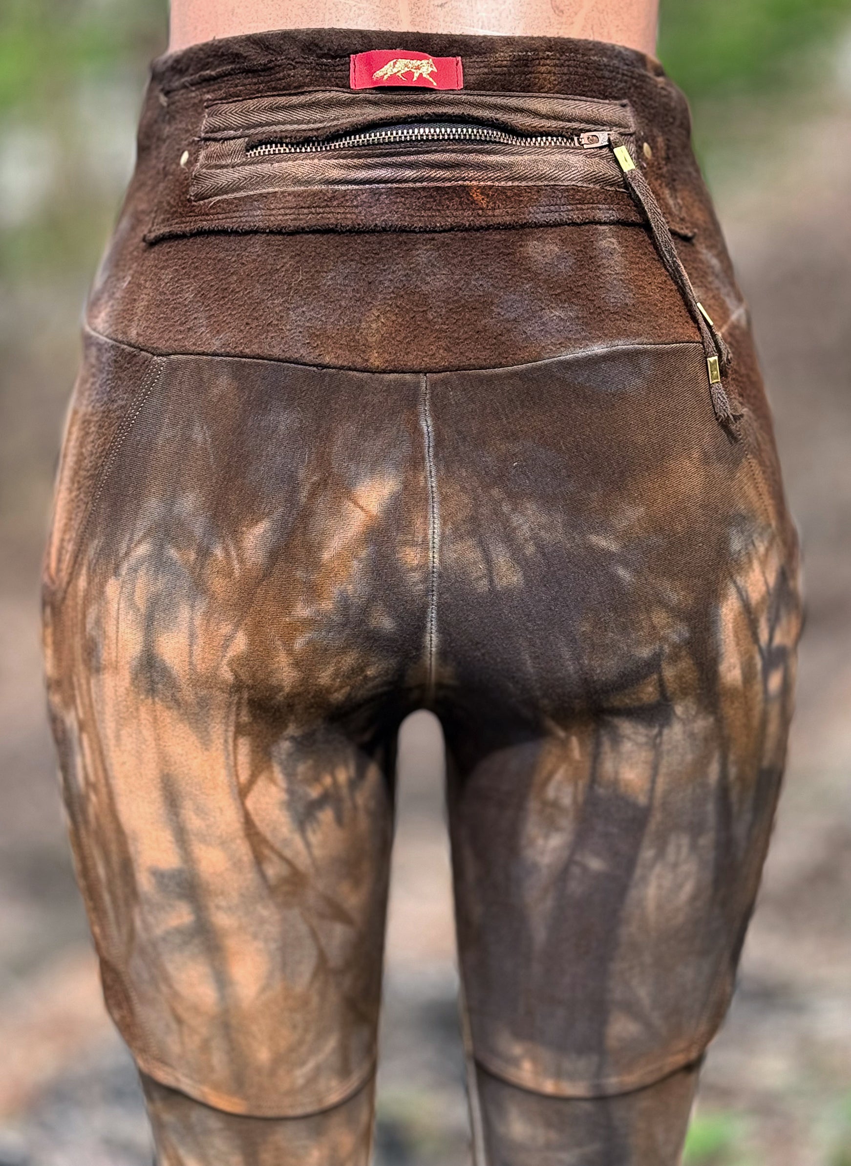 Close-up of a suede back pocket with zipper and Crossfox leather patch