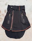 Navy zippered jacket with red trim, front pockets, and ribbed knit hem on light gray surface