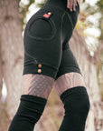 Relaxed black suede jacket with contrast stitching and snap button cuffs in soft outdoor light