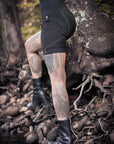 Rugged unbranded cargo shorts in black denim with contrast stitching and snap button pockets